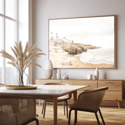 Fine art of Sunset Cliffs, San Diego California horizontal print of hazy high-angle landscape beach photography captures a light blue ocean meeting tall tan, brown cliffs rise as iconic coastal scenery. Photograph in minimalist mock up.