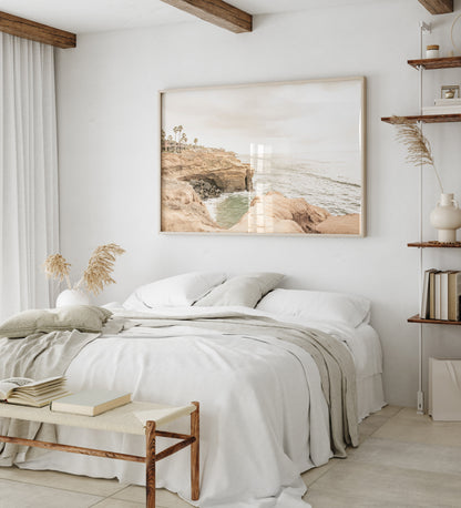 Fine art of Sunset Cliffs, San Diego California horizontal print of hazy high-angle landscape beach photography captures a light blue ocean meeting tall tan, rocky, brown cliffs rise as iconic coastal scenery. Photograph in minimalist mock up.