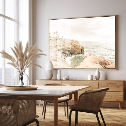Fine art of Sunset Cliffs, San Diego California horizontal print of hazy high-angle landscape beach photography captures a light blue ocean meeting tall tan, rocky, brown cliffs rise as iconic coastal scenery. Photograph in minimalist mock up.