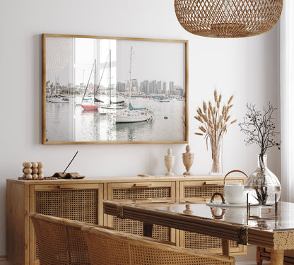 A horizontal San Diego print showcasing numerous sailboats in San Diego Harbor with the city skyline in the background. This modern coastal print embodies the Southern California coastal photography, perfect for a large beach wall art. Photograph in minimalist mock up.