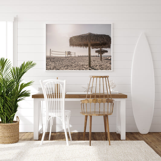 Photography by Kim Dybczak of: A simple lifeguard tower stands on the sand, with gentle waves behind it.