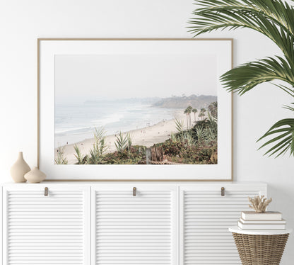 Landscape San Diego beach print showing seascape with gentle ocean waves in the water near a sandy cliff. Photograph in minimalist mock up.