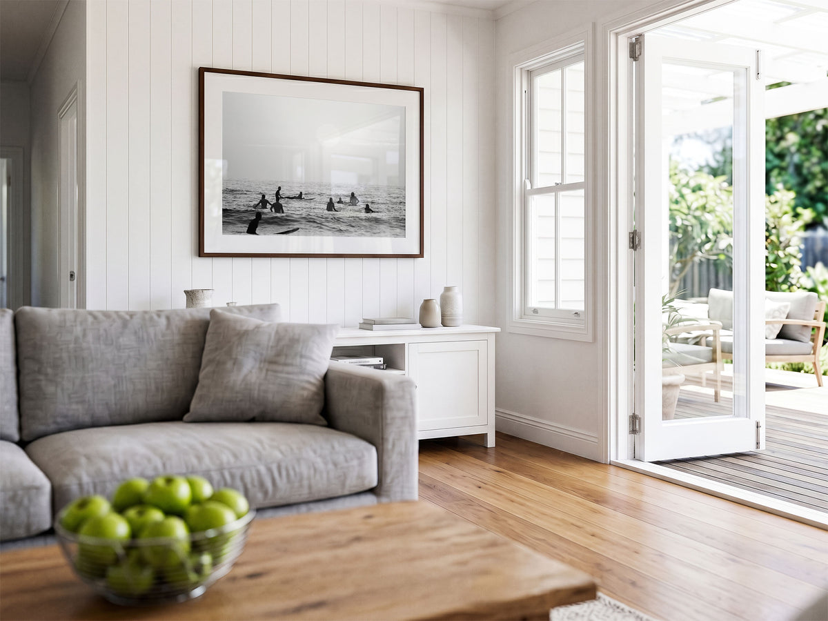 Framed photo of: Swamis 6683 displayed on a coastal living room wall above a console. 