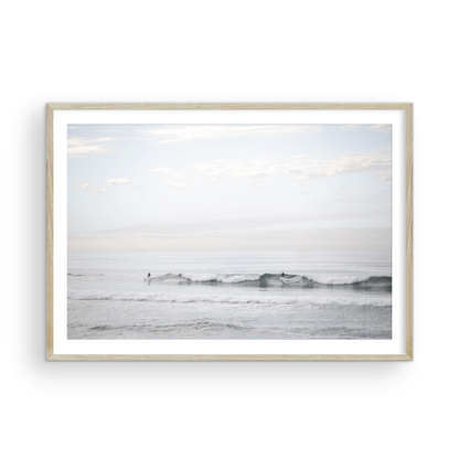 Horizontal minimalist ocean art with a close-up blue waves print of water, featuring subtle ripples and soft textures, ideal as a neutral ocean print, surfers in the waves. Photograph in minimalist mock up.