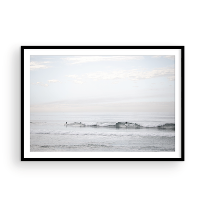 Horizontal minimalist ocean art with a close-up blue waves print of water, featuring subtle ripples and soft textures, ideal as a neutral ocean print, surfers in the waves. Photograph in minimalist mock up.