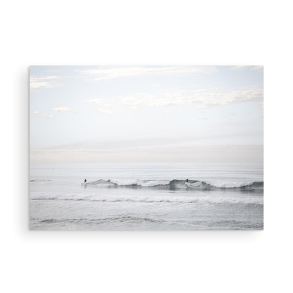 Horizontal minimalist ocean art with a close-up blue waves print of water, featuring subtle ripples and soft textures, ideal as a neutral ocean print, surfers in the waves. Photograph in minimalist mock up.