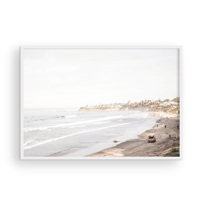 Landscape surf wall decor at Pacific Beach, San Diego, with numerous surfers in the water and a residential cliffside. Photograph in minimalist mock up.