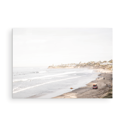 Landscape surf wall decor at Pacific Beach, San Diego, with numerous surfers in the water and a residential cliffside. Photograph in minimalist mock up.