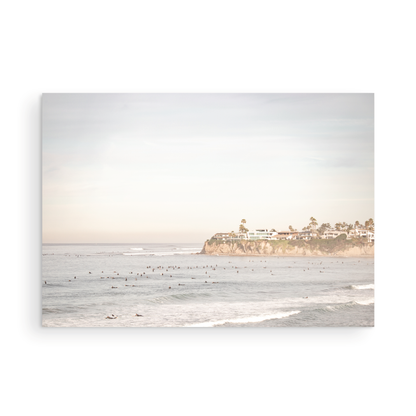 Landscape San Diego beach print of Tourmaline Beach, Pacific Beach, San Diego, showing a large group of surfers in the water near a residential cliff. This surf vibes print captures the local surf scene. Photograph in minimalist mock up.