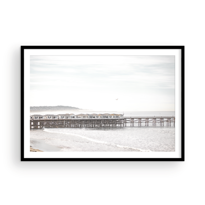 Landscape coastal photography of Crystal Pier in Pacific Beach, San Diego, extending into the calm ocean with gentle waves. Photograph in minimalist mock up