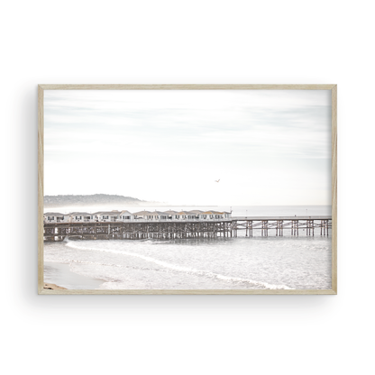 Landscape coastal photography of Crystal Pier in Pacific Beach, San Diego, extending into the calm ocean with gentle waves. Photograph in minimalist mock up