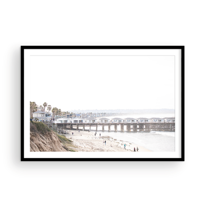 Landscape San Diego beach print of Pacific Beach's Crystal Pier, featuring its unique houses extending over the water, with people on the sandy shore. This iconic beach print is great for beach decor. Photograph in minimalist mock up.