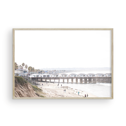 Landscape San Diego beach print of Pacific Beach's Crystal Pier, featuring its unique houses extending over the water, with people on the sandy shore. This iconic beach print is great for beach decor. Photograph in minimalist mock up.