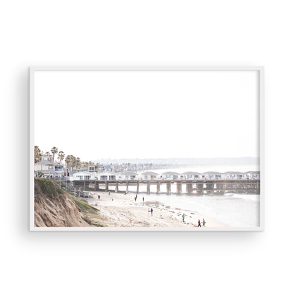 Landscape San Diego beach print of Pacific Beach's Crystal Pier, featuring its unique houses extending over the water, with people on the sandy shore. This iconic beach print is great for beach decor. Photograph in minimalist mock up.