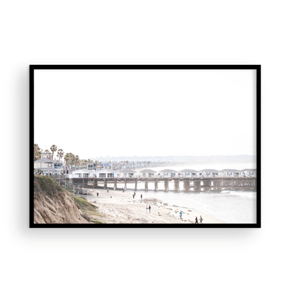 Landscape San Diego beach print of Pacific Beach's Crystal Pier, featuring its unique houses extending over the water, with people on the sandy shore. This iconic beach print is great for beach decor. Photograph in minimalist mock up.