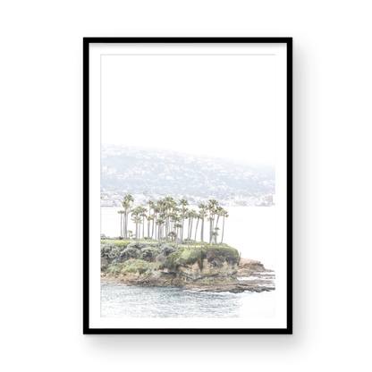 Vertical coastal photography of Laguna Beach, San Diego, featuring a fine art giclee print featuring palm trees on a small island in a body of water. Photograph in minimalist mock up.