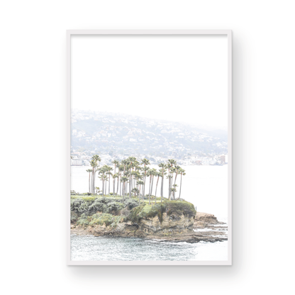 Vertical coastal photography of Laguna Beach, San Diego, featuring a fine art giclee print featuring palm trees on a small island in a body of water. Photograph in minimalist mock up.