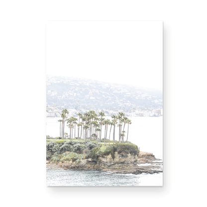 Vertical coastal photography of Laguna Beach, San Diego, featuring a fine art giclee print featuring palm trees on a small island in a body of water. Photograph in minimalist mock up.