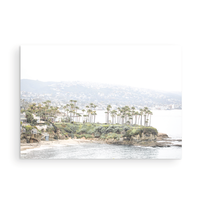 Horizontal coastal photography of Laguna Beach, San Diego, featuring a fine art giclee print featuring palm trees on a small island in a body of water. Photograph in minimalist mock up.