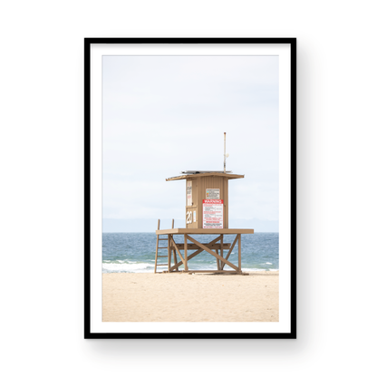 A wide landscape coastal photography view of Newport Beach in Southern California, featuring a lifeguard tower and walls on the beach. Photograph in minimalist mock up.
