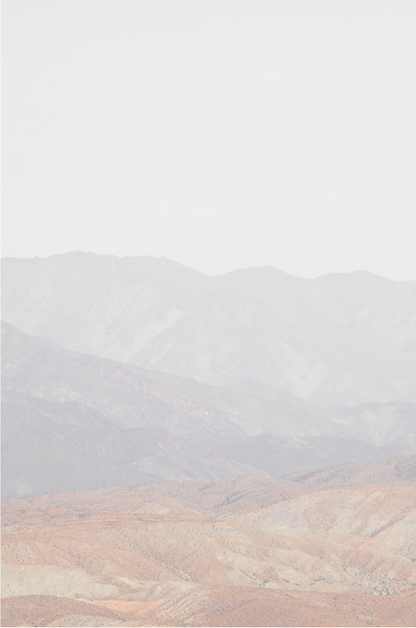 Minimalist art print of hazy mountains layered in soft tones, creating a calm ocean print aesthetic. This vertical minimalist art print can fit a neutral ocean print theme. 