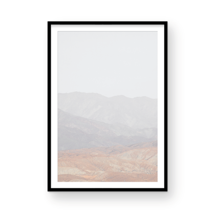 Minimalist art print of hazy mountains layered in soft tones, creating a calm ocean print aesthetic. This vertical minimalist art print can fit a neutral ocean print theme. Photograph in minimalist mock up.