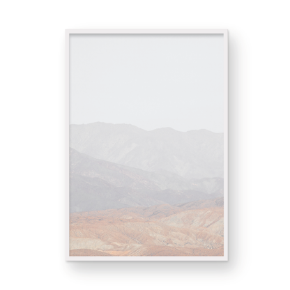 Minimalist art print of hazy mountains layered in soft tones, creating a calm ocean print aesthetic. This vertical minimalist art print can fit a neutral ocean print theme. Photograph in minimalist mock up.