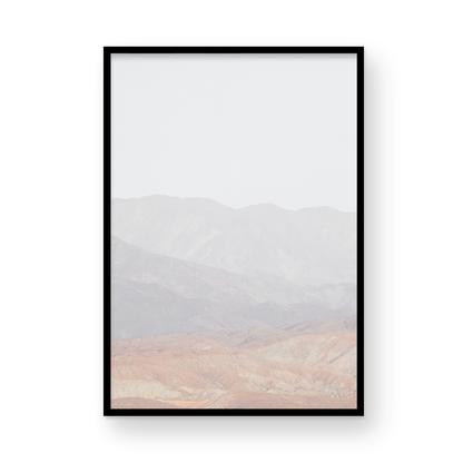 Minimalist art print of hazy mountains layered in soft tones, creating a calm ocean print aesthetic. This vertical minimalist art print can fit a neutral ocean print theme. Photograph in minimalist mock up.
