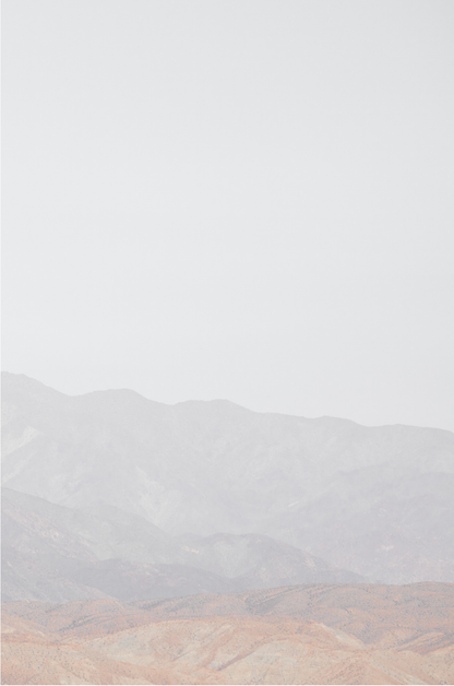 Minimalist art print of hazy mountains layered in soft tones, creating a calm ocean print aesthetic. This vertical minimalist art print can fit a neutral ocean print theme. 