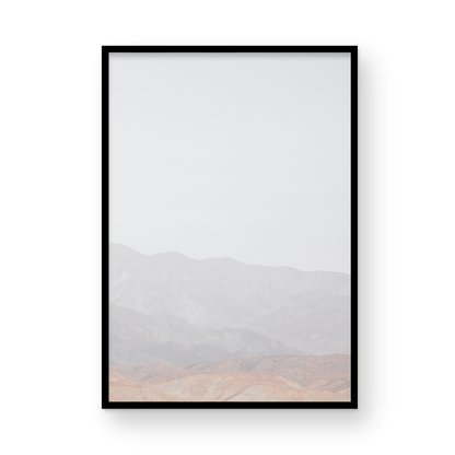 Minimalist art print of hazy mountains layered in soft tones, creating a calm ocean print aesthetic. This vertical minimalist art print can fit a neutral ocean print theme. Photograph in minimalist mock up.