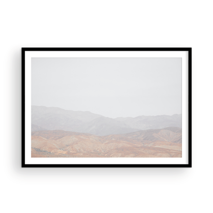Minimalist art print of hazy mountains layered in soft tones, creating a calm ocean print aesthetic. This horizontal minimalist art print can fit a neutral ocean print theme. Photograph in minimalist mock up.