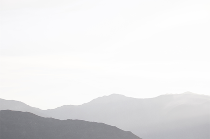 Minimalist horizontal art print of hazy mountains layered in soft tones. Located in Palms Springs, California.