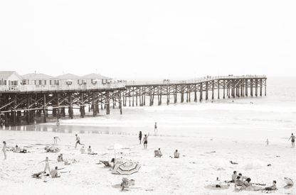 Sepia beach photo of Crystal Pier in Pacific Beach, San Diego, with people on the sandy beach. This framed coastal print showcases iconic beach scenes. 