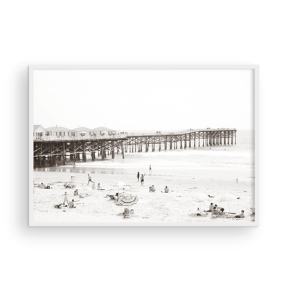 Sepia beach photo of Crystal Pier in Pacific Beach, San Diego, with people on the sandy beach. This framed coastal print showcases iconic beach scenes. Photograph in minimalist mock up.
