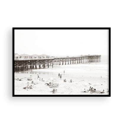 Sepia beach photo of Crystal Pier in Pacific Beach, San Diego, with people on the sandy beach. This framed coastal print showcases iconic beach scenes. Photograph in minimalist mock up.