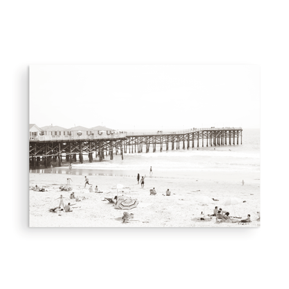 Sepia beach photo of Crystal Pier in Pacific Beach, San Diego, with people on the sandy beach. This framed coastal print showcases iconic beach scenes. Photograph in minimalist mock up.