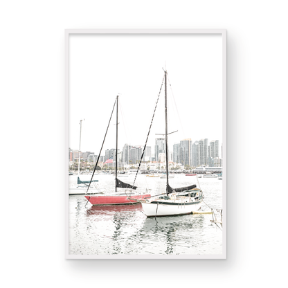 A vertical San Diego print showcasing numerous sailboats in San Diego Harbor with the city skyline in the background. This modern coastal print embodies the Southern California coastal photography, perfect for a large beach wall art. Photograph in minimalist mock up.