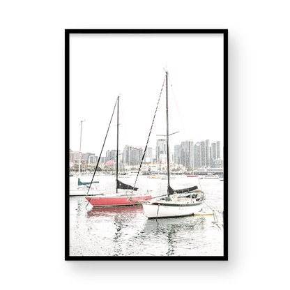 A vertical San Diego print showcasing numerous sailboats in San Diego Harbor with the city skyline in the background. This modern coastal print embodies the Southern California coastal photography, perfect for a large beach wall art. Photograph in minimalist mock up.
