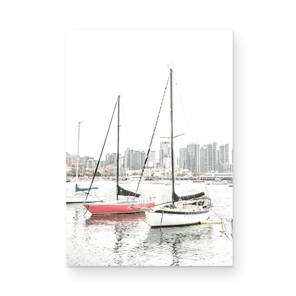 A vertical San Diego print showcasing numerous sailboats in San Diego Harbor with the city skyline in the background. This modern coastal print embodies the Southern California coastal photography, perfect for a large beach wall art. Photograph in minimalist mock up.