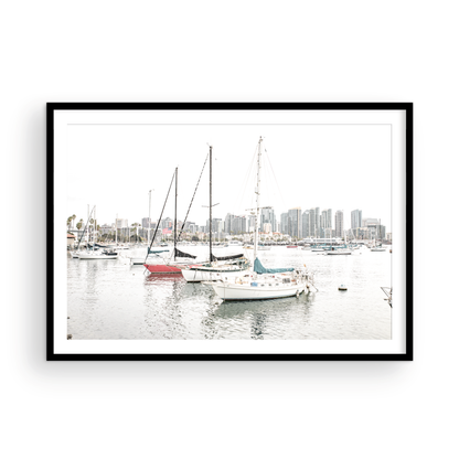 A horizontal San Diego print showcasing numerous sailboats in San Diego Harbor with the city skyline in the background. This modern coastal print embodies the Southern California coastal photography, perfect for a large beach wall art. Photograph in minimalist mock up.