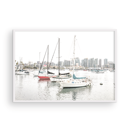 A horizontal San Diego print showcasing numerous sailboats in San Diego Harbor with the city skyline in the background. This modern coastal print embodies the Southern California coastal photography, perfect for a large beach wall art. Photograph in minimalist mock up.