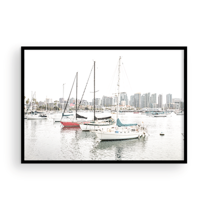 A horizontal San Diego print showcasing numerous sailboats in San Diego Harbor with the city skyline in the background. This modern coastal print embodies the Southern California coastal photography, perfect for a large beach wall art. Photograph in minimalist mock up.