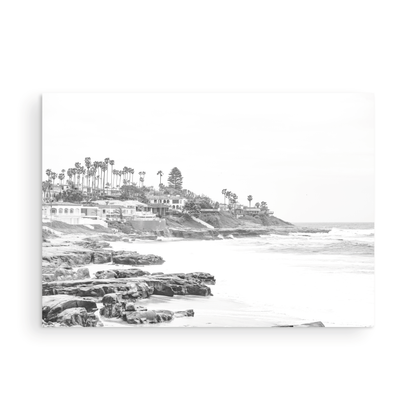 Fine art of WindanSea Beach, La Jolla California horizontal landscape black and white print by Southern California photographer Kim Dybczak of Salt Creek Prints, featuring a powerful waves crashing against the rocky shore of California coast. Beach homes and palm trees sit atop the cliffside, with stairs leading down to a sheltered area. Photograph in minimalist framed mock up