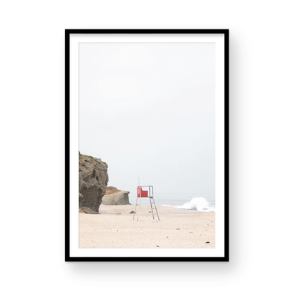 Vertical coastal photography featuring a red and white lifeguard chair and a calm ocean background, located in Laguna California. Photograph in minimalist mock up.
