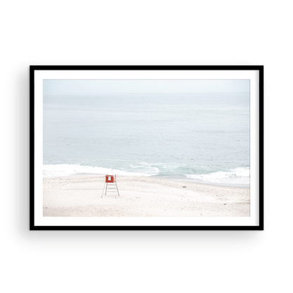 Horizontal coastal photography featuring a red and white lifeguard chair and a calm ocean background, located in Laguna California. Photograph in minimalist mock up.