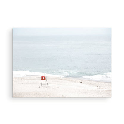 Horizontal coastal photography featuring a red and white lifeguard chair and a calm ocean background, located in Laguna California. Photograph in minimalist mock up.