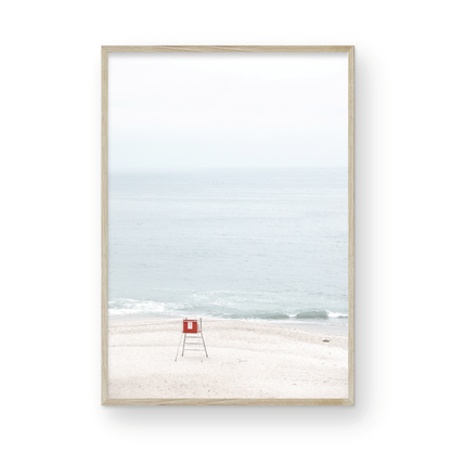 Vertical coastal photography featuring a red and white lifeguard chair and a calm ocean background, located in Laguna California. Photograph in minimalist mock up.