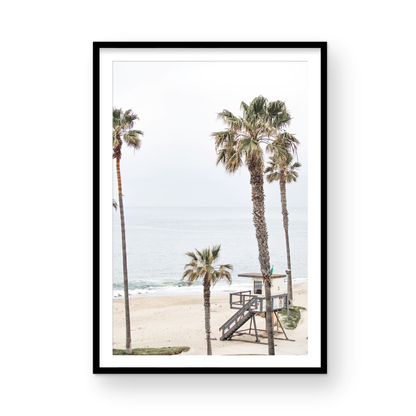 Vertical coastal photography of a coastal scene with palm trees and a lifeguard tower at Aliso Beach, Laguna California, with a wooden frame. Photograph in minimalist mock up.