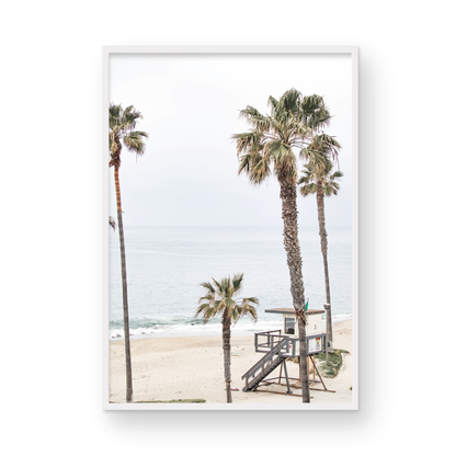 Vertical coastal photography of a coastal scene with palm trees and a lifeguard tower at Aliso Beach, Laguna California, with a wooden frame. Photograph in minimalist mock up.