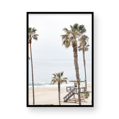 Vertical coastal photography of a coastal scene with palm trees and a lifeguard tower at Aliso Beach, Laguna California, with a wooden frame. Photograph in minimalist mock up.